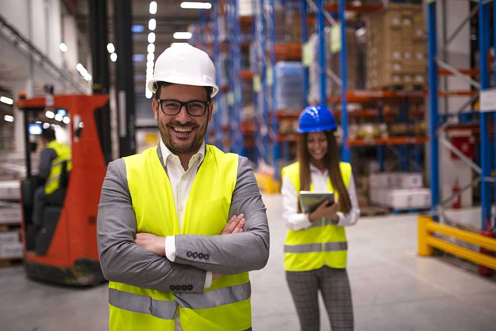 Uomo e donna che lavorano all'interno di un magazzino logistico